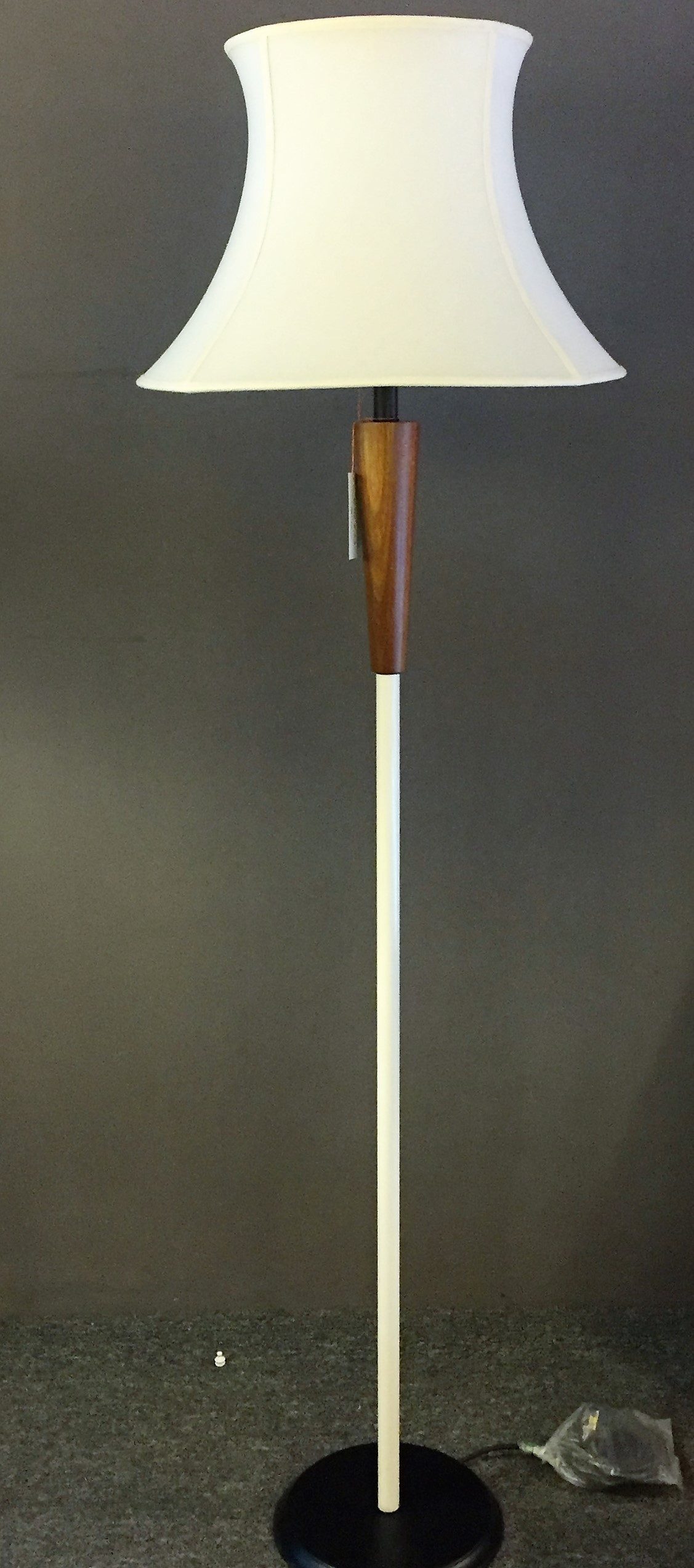 Slim black floor lamp with a rectangular linen shade