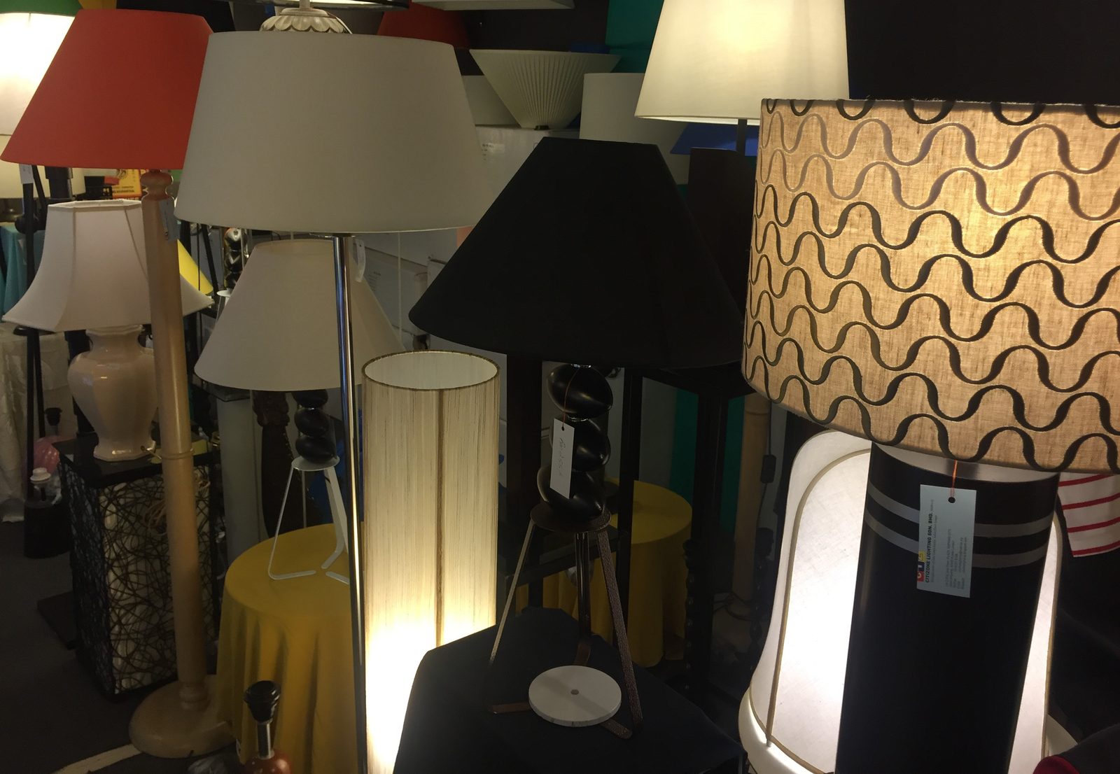 Row of assorted fabric lampshades on stands