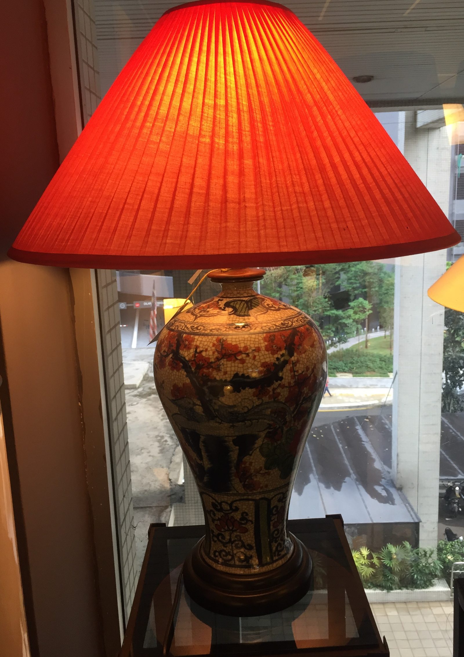 Tall table lamp with a warm orange fabric shade